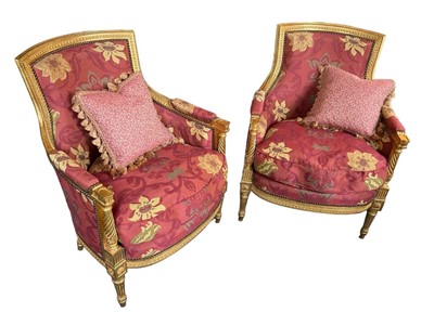 Lot 1140 - Pair of Louis XVI style carved gilt tub chairs, with fluted and boss ornament on tapered legs