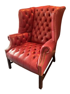 Lot 1147 - George III style leather upholstered wing armchair