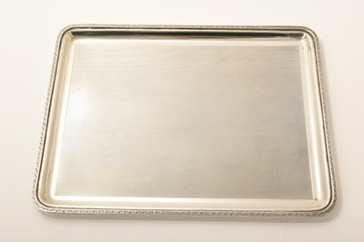 Lot 414 - George V silver dressing table tray of rectangular form, with engine turned decoration and foliate border (London 1923)