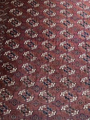 Lot 1174 - Tekke Tukoman rug, having five rows of twelve quartered  guls on claret ground, 300cm x 220cm