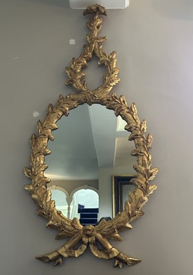 Lot 1175 - George II style giltwood wall mirror, oval plate within oak leaf meandering frame, 126cm x 61cm