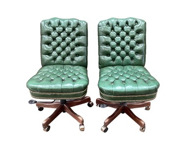 Lot 1193 - Pair of green button leather swivel desk chairs raised on castors