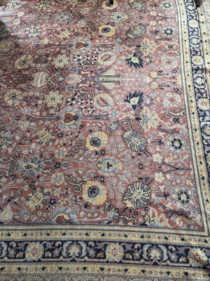 Lot 1211 - Woollen carpet, with all over foliate lotus design on brick red ground, 400cm x 285cm