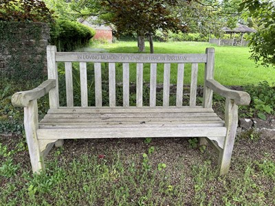 Lot 1219 - Pair of teak garden benches with engraved memorial inscriptions, 150cm long