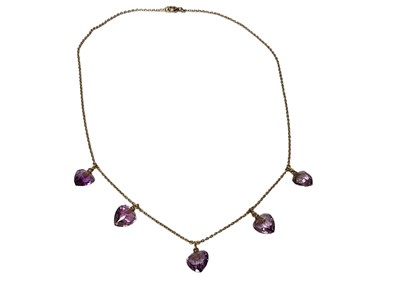 Lot 221 - Edwardian amethyst and gold fringe necklace with five facet cut heart-shape pendant drops