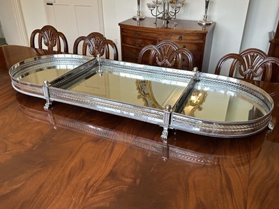 Lot 374 - A good Georgian style mirrored silver plated table plateau, oblong form with pierced gallery raise on lion paw feet, 130cm long