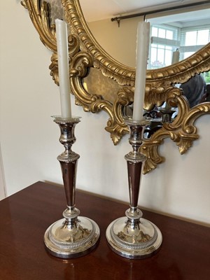 Lot 376 - Pair of Old Sheffield plate candlesticks with removable sconces on gadrooned borders, 30cm high