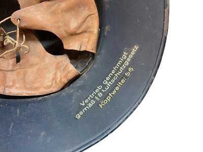 Lot 755 - Second World War Nazi Luftschutz helmet with original paint, transfer badge and liner.