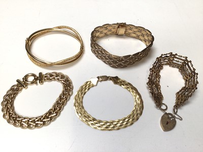 Lot 238 - 9ct gold gate bracelet with padlock clasp, three 9ct gold woven link bracelets and a 9ct gold hinged double bangle (5)