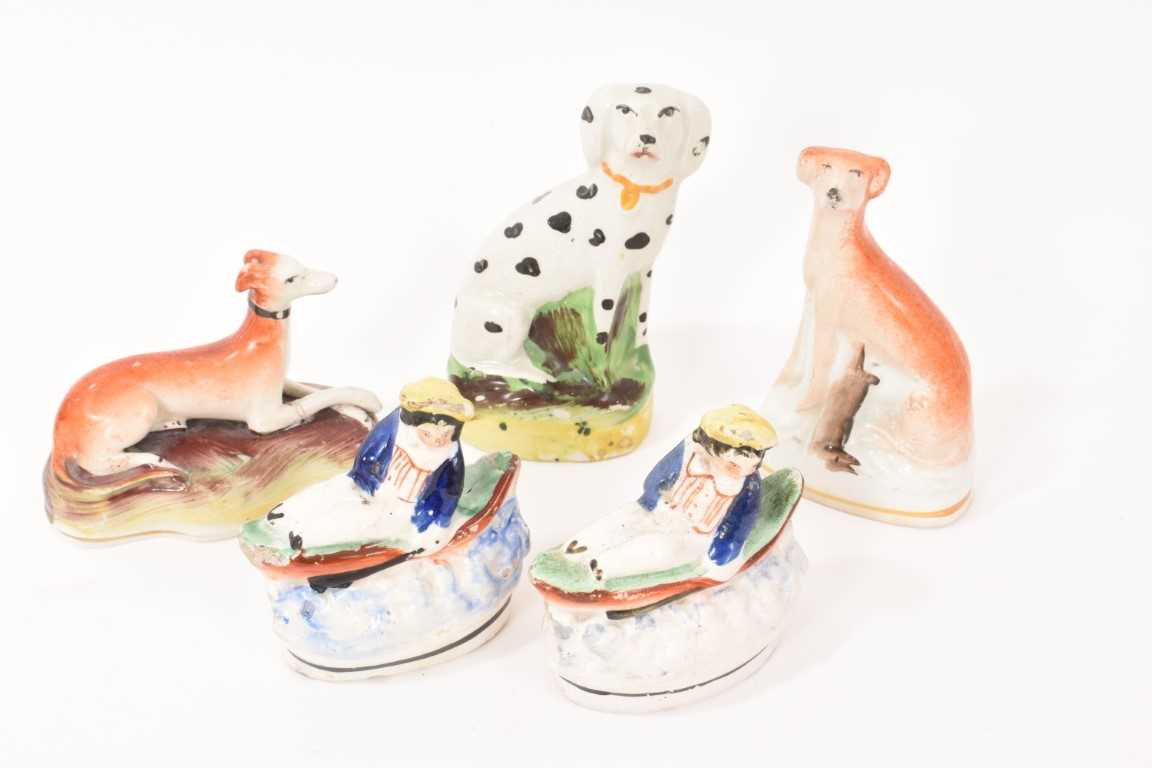 Lot 11 - Two Staffordshire pottery greyhounds, a Dalmatian and two small Staffordshire groups of a boy in a boat