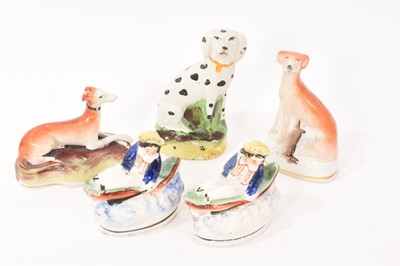 Lot 11 - Two Staffordshire pottery greyhounds, a Dalmatian and two small Staffordshire groups of a boy in a boat