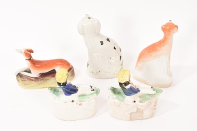 Lot 11 - Two Staffordshire pottery greyhounds, a Dalmatian and two small Staffordshire groups of a boy in a boat