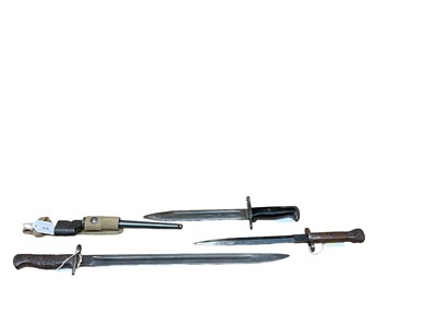 Lot 976 - British spike bayonet with scabbard and frog and three other bayonets (scabbards lacking) (4)