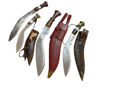 Lot 981 - Four old Kukris (three with scabbards)