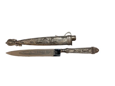 Lot 982 - South American cowboy's gaucho knife with silver plated handle and scabbard decorated with bull lassoing scenes with etched blade