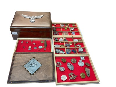 Lot 785 - Large collection of Nazi badges, pins and medals (both original and reproductions noted), housed in a mahogany box with applied swastika decoration, approximately 50 items.