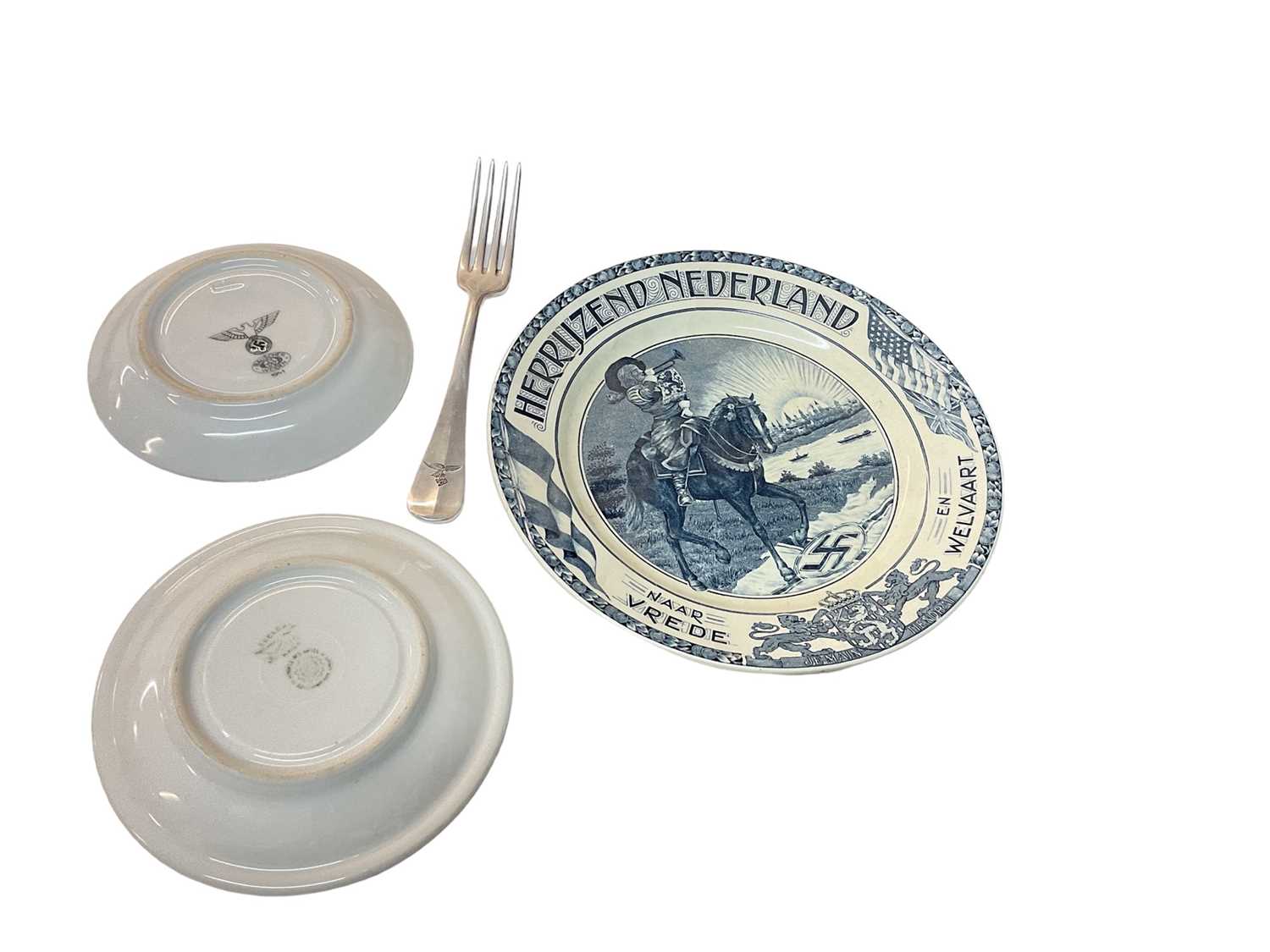 Lot 786 - Two Nazi porcelain saucers, together with a Luftwaffe fork and a Dutch blue and white anti Nazi plate