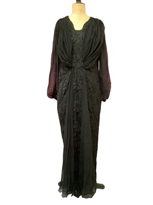 Lot 2117 - Black lace evening gown with silk crepe sleeves and pleated drapes to bodice and skirt, c1910.