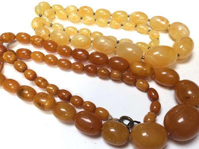 Lot 278 - Amber bead necklace (possibly reconstituted) with graduated polished oval beads, 69cm long, together with a vintage plastic bead necklace (2)