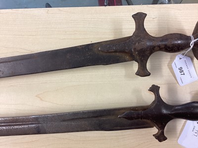 Lot 987 - Two 19th century Indian Tulwars with traditional disc hilts and curved fullered blades