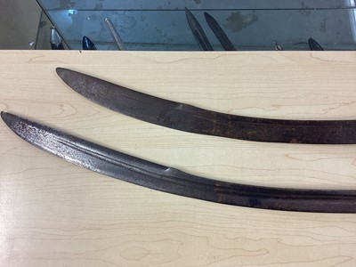 Lot 987 - Two 19th century Indian Tulwars with traditional disc hilts and curved fullered blades