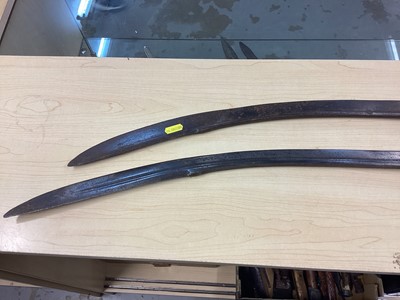 Lot 987 - Two 19th century Indian Tulwars with traditional disc hilts and curved fullered blades