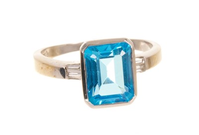 Lot 544 - Blue topaz and diamond ring with a rectangular step cut blue topaz measuring approximately 10 x 8mm, approximately 3.90cts, flanked by two tapered baguette cut diamonds to the shoulders in 18ct whi...