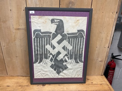 Lot 809 - Second World War era Nazi flag fragment mounted in glazed frame with caption 'centre cut from Nazi flag believed to be from DRL sports association', fragment measuring 60.5 x 48.4cm.