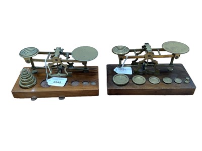 Lot 2545 - Two pairs Victorian brass postal scales by S.Mordan & Co, London on walnut bases complete with brass graduated weights (2)