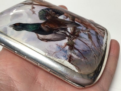 Lot 315 - Early 20th century Continental silver and enamel cigarette case of rectangular cushion cover, the front enamelled with a capercaillie in a Scottish woodland scene, marked 935, 9cm in length.