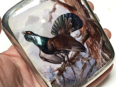 Lot 315 - Early 20th century Continental silver and enamel cigarette case of rectangular cushion cover, the front enamelled with a capercaillie in a Scottish woodland scene, marked 935, 9cm in length.