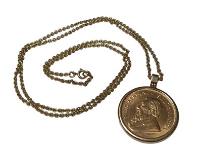 Lot 330 - South Africa 1975 Krugerrand in yellow metal pendant mount, on 18ct gold chain, with original receipt and box.