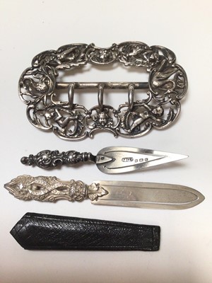 Lot 322 - George V silver belt buckle, (London 1911), maker William Comyns, together with a Victorian silver book mark, (Birmingham 1876) and an Edwardian silver trowel book mark (Birmingham 1906), (3)