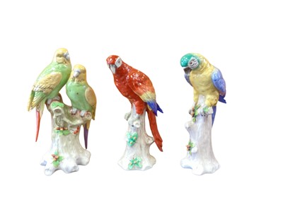 Lot 1264 - Three Sitzendorf porcelain parrots on naturalistic bases