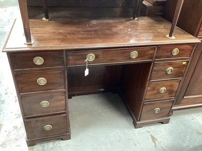 Lot 1275 - Edwardian mahogany knee-hole pedestal desk fitted with nine drawers, on bracket feet, 119cm wide