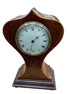 Lot 2589 - Early 20th mahogany mantle clock with French movement in shaped Art Nouveau style case with brass inlaid decoration, key present, 26cm in overall height.