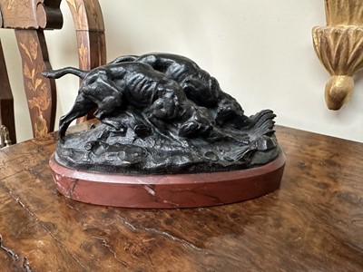 Lot 1524 - After Barye bronze group of two hunting dogs, raised on rouge marble plinth