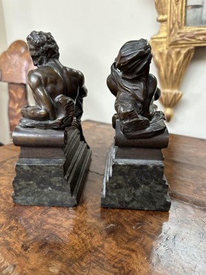 Lot 1527 - Pair of bronze bookends after Michaelangelo