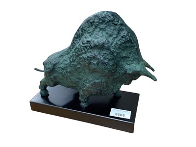 Lot 430 - Bronzed patinated metal sculpture of a bull on black base, 22cm in length