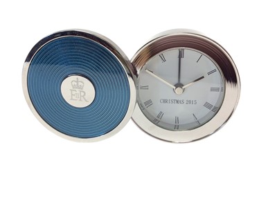 Lot 67 - H.M.Queen Elizabeth II, 2015 Royal Household Christmas present silver plated and enamel circular travelling alarm clock with engraved crowned ERII cypher in cotton bag and original box with card