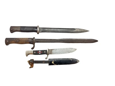 Lot 971 - First World War Imperial German bayonet, together with a Second World War German bayonet (both lacking scabbards), and a Post War copy of a Hitler Youth knife (3).