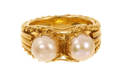 Lot 553 - Gold and cultured pearl ring with two button cultured pearls on a tapered gold band with rope twist edge, ring size N.