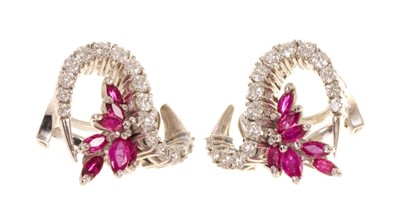 Lot 557 - Pair of 1960s Vacheron Constantin diamond and ruby earrings, the stylized floral scroll with marquise cut rubies and graduated brilliant cut diamonds in 18ct white gold setting with clip fitting, s...