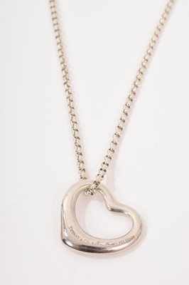 Lot 555 - Tiffany silver heart pendant on chain, designed by Elsa Peretti, signed, on a silver trace chain.