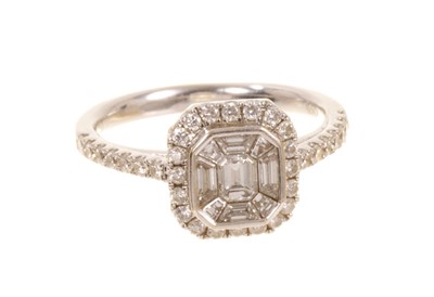 Lot 549 - Diamond cluster ring, the octagonal cluster with a cluster of emerald cut and step cut diamonds surrounded by a border of brilliant cut diamonds with diamond set shoulders. Ring size L½.