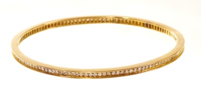 Lot 567 - Diamond bangle with a full band of brilliant cut diamonds in yellow gold setting. Estimated total diamond weight approximately 1.5ct-2cts.