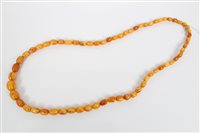 Lot 404 - Old amber necklace with a string of graduated...