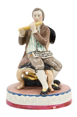 Lot 277 - Pearlware figure of a seated musician, on oval base, circa 1810