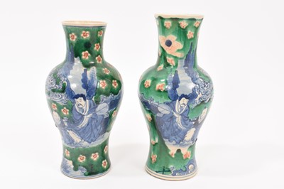 Lot 260 - Near pair of Chinese crackle glaze vases, decorated in underglaze blue with figures on a green and iron red ground, Kangxi marks but later, 18cm and 19cm high