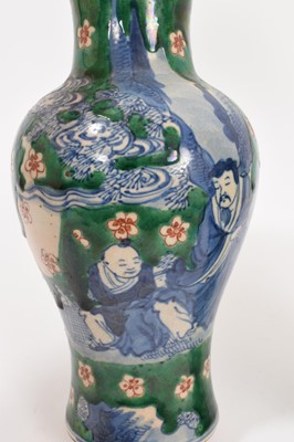 Lot 260 - Near pair of Chinese crackle glaze vases, decorated in underglaze blue with figures on a green and iron red ground, Kangxi marks but later, 18cm and 19cm high